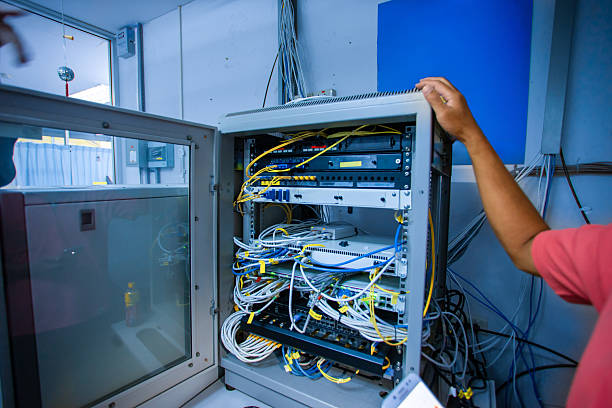 Network Equipment and Cables in Server Room Cabinet Arrangement