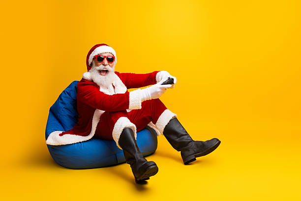 istock Charismatic Santa Claus Relaxing and Gaming in a Funky Modern Setup 2236102290
