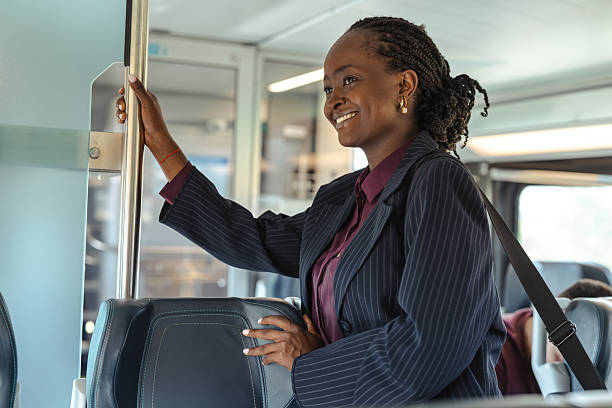 istock Professional woman smiling while standing on public transportation during her commute 2236103790