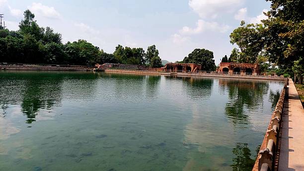 istock Serene Ancient Pool with Brick Archways and Lush Green Surroundings 2236103947