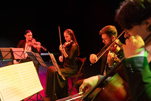 istock Elegant Quartet Performing Classical Music in Low Lighting with Focused Musicians 2236105640
