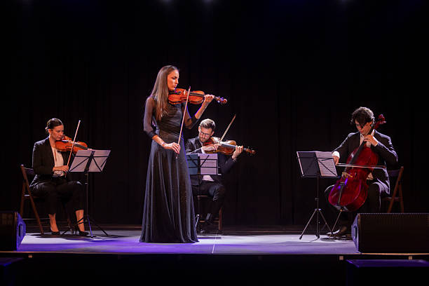 istock Elegant Quartet Performing on Stage with Graceful Violinist and String Instruments 2236105656