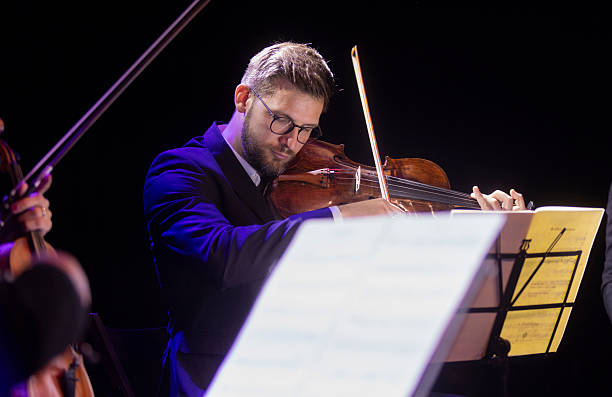 istock Male Violinist in Sophisticated Concert Setting Playing with Passion and Precision 2236105657