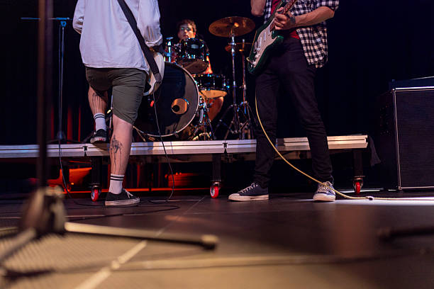 istock Energetic Live Band Performance with Drums and Guitars Under Stage Lights 2236105700