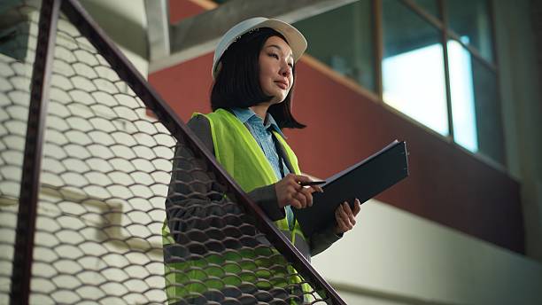 istock Asian Japanese woman builder in hard hat hold tablet reading building plan construction businesswoman architect Korean Chinese contractor business female girl civil engineer inspector check document 2236106842