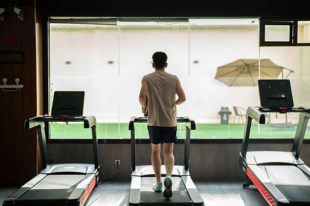 istock Asian man running on treadmill in gym 2236107612