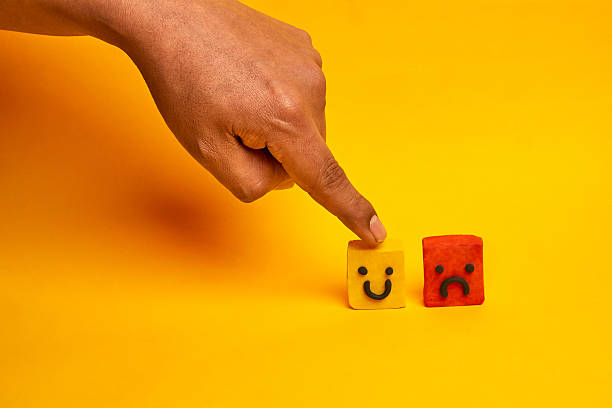istock A finger choosing a happy face over a sad face illustrates customer satisfaction decision making, representing feedback evaluation and service improvement. 2236108023