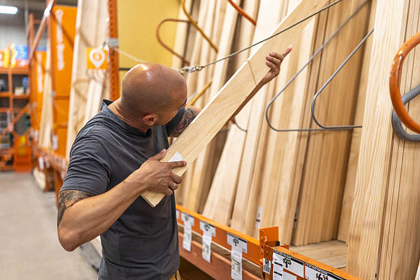 istock Man Selecting Wooden Plank in Hardware Store 2236108887