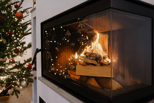 istock Cozy Fireplace with Burning Wood and Christmas Tree Decorations 2236108914