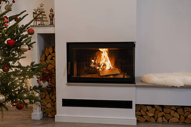 istock Cozy Fireplace with Burning Wood and Christmas Tree Decorations 2236108935
