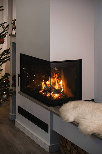 istock Cozy Fireplace with Burning Wood and Christmas Tree Decorations 2236108957