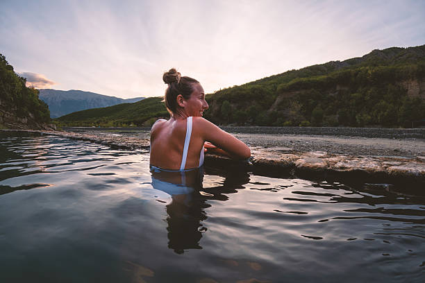 istock Woman Relaxing in Natural Hot Spring at Sunset 2236112983