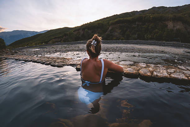 istock Woman Relaxing in Natural Hot Spring at Sunset 2236112984