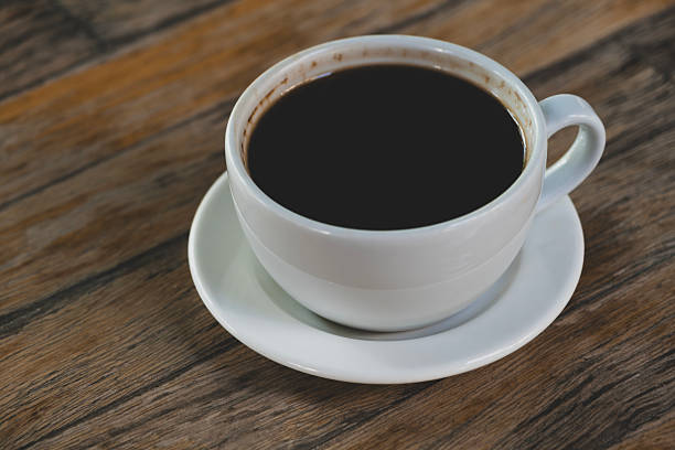 istock Cup of coffee on wooden table. 2236115695