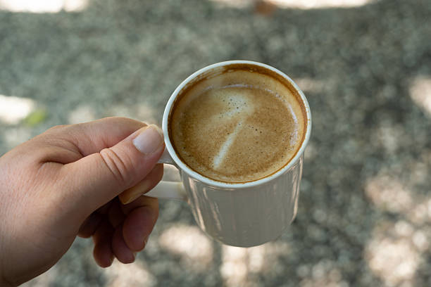 istock Warm cup of coffee held in hand. 2236115894