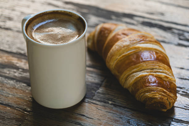 istock Latte Coffee and Croissant on Wooden Table. 2236115998