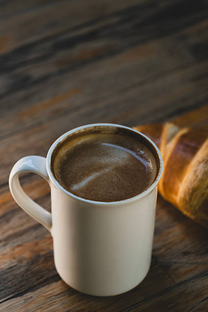 istock Latte Coffee and Croissant on Wooden Table. 2236116094