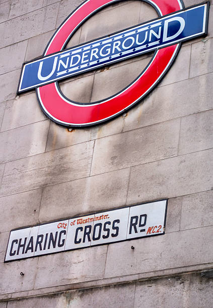An old-fashioned street sign and London underground sign on the wall of Leicester Square Station in Charing Cross Road, WC2, in the Theatreland district of the City of Westminster. This part of London is known as Theatreland because of the many theatres and cinemas in the area.