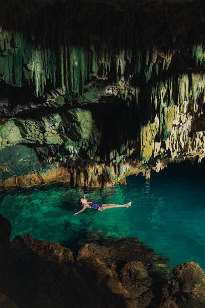 istock Traveller Floating in Majestic Hidden Cave on Crystal Blue Water 2236116815