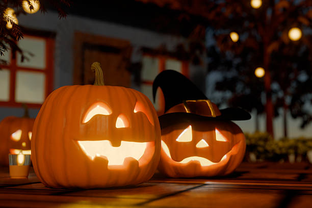 istock Halloween carved pumpkins with glowing faces and a witch hat on a wooden surface. 3d rendering 2236116910