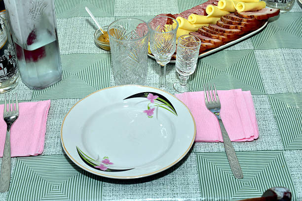 Ceramic plate and cutlery stand on the table, top view.