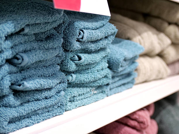 istock Stack of blue folded towels - A Stack of Neatly Folded, Soft Blue Towels on a Store Shelf 2236119272