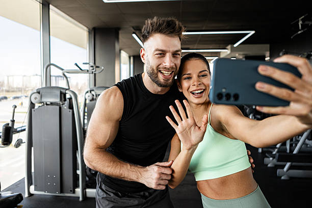 istock Young couple taking gym selfie with smartphone 2236120375