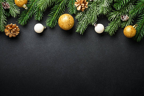 istock Christmas decorations and spruce tree at black background. 2236120875