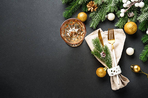 istock Modern golden cutlery and christmas decorations at black. 2236120889