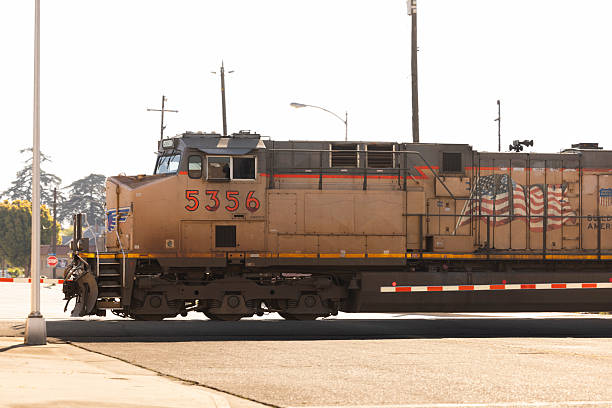 Selma, California, USA - March 24, 2025: A Union Pacific freight train passes through an at grade crossing in downtown.