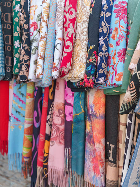 istock Colorful Patterned Scarves Hanging in Vertical Display 2236121141