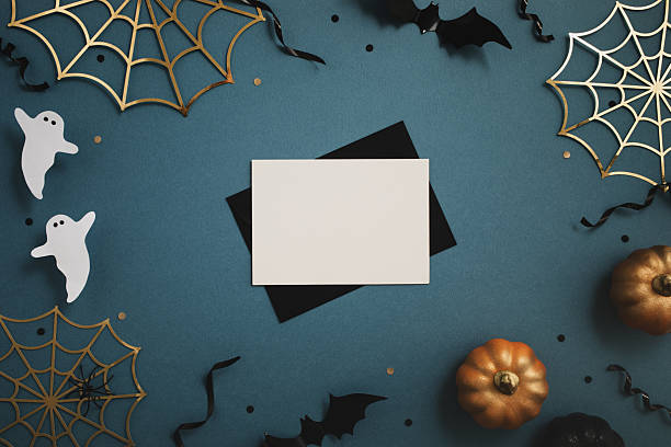 istock Halloween party composition with empty card and pumpkins, bats, spider web, ghosts on blue background top view. 2236121288