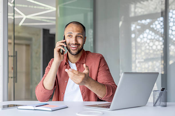 istock Happy businessman talking on the phone and working in a modern office. 2236123324