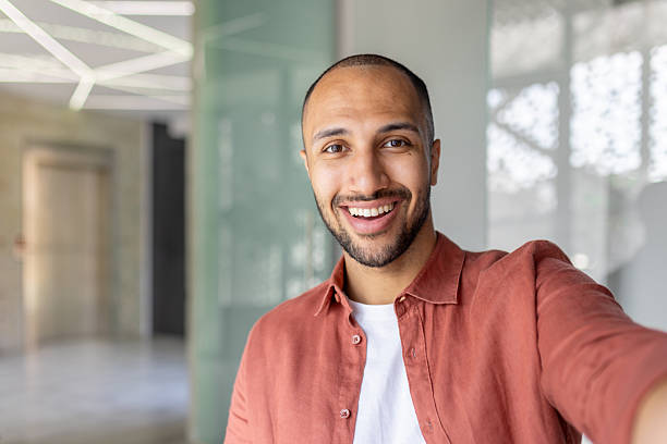 istock Smiling young man takes fun photo in modern office environment 2236123343