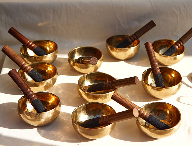 istock Collection of brass singing bowls arranged on a soft light mallets, showcasing craftsmanship and inviting tranquility for meditation and relaxation 2236125027