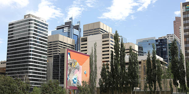 Calgary, Canada - August 20, 2025: Looking northeast from 6th Avenue Southwest. A mural of a peregrine falcon by artist birdO, Jerry Rugg, stands among the commercial buildings of 4th Street Southwest near 5th Avenue Southwest.