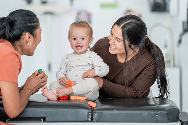 istock Smiling Toddler With Two Women in a Bright Modern Setting 2236131357