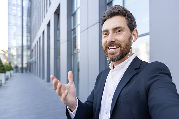 istock Happy businessman having a video call while outdoors in a city area 2236132170