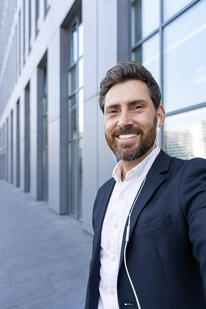 istock Smiling businessman taking a call outdoors in a modern urban setting 2236132173