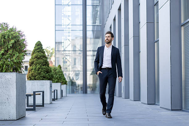 istock Business professional walking confidently outside a modern corporate office building 2236132267
