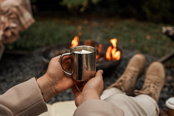 istock Cozy evening by the campfire with a warm drink 2236132768