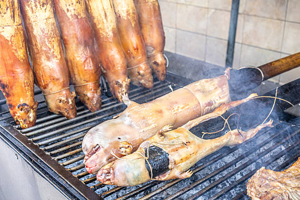 Typical food of Ecuador: guinea pig roasting on the grill, prepared with traditional Andean techniques that preserve cultural essence and offer a unique gastronomic experience.