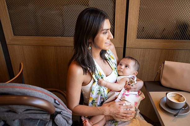 istock mother carrying her baby in her arms while giving him a pacifier 2236133290
