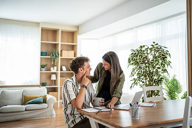 istock Couple collaborating on home office project in living room 2236135484