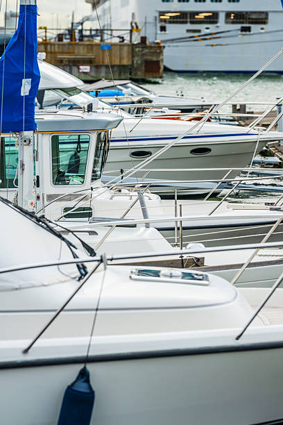 istock Closeup view of several docked white boats.. 2236137959