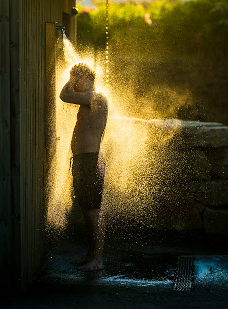 Boy playing with the dusty road at sunset