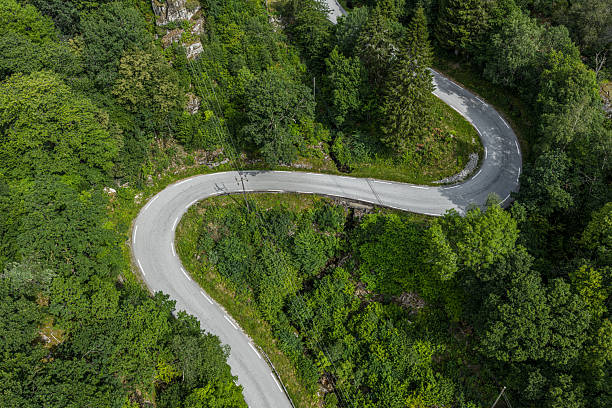 istock Curved mountain road winding through dense forest.. 2236138121