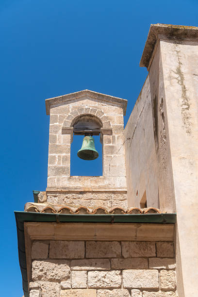 istock Ancient Stone Bell Tower Against Clear Blue Sky 2236148442