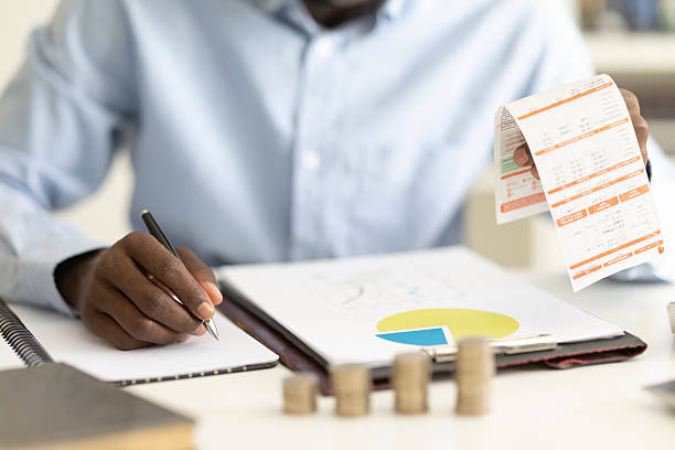 istock Person analyzing bills and documents, managing personal finances and budgeting 2236149562
