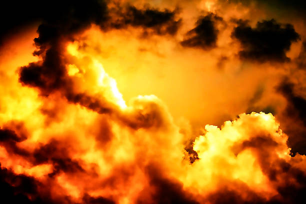 Cloud - the heart of love on the background of the sunset orange sky